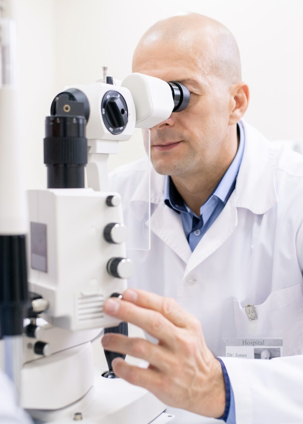 middle-aged-professional-optometrist-checking-eyesight-of-female-patient