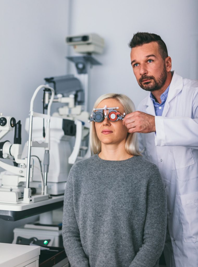 optician-checking-patient-s-eyesight-with-trial-frame-