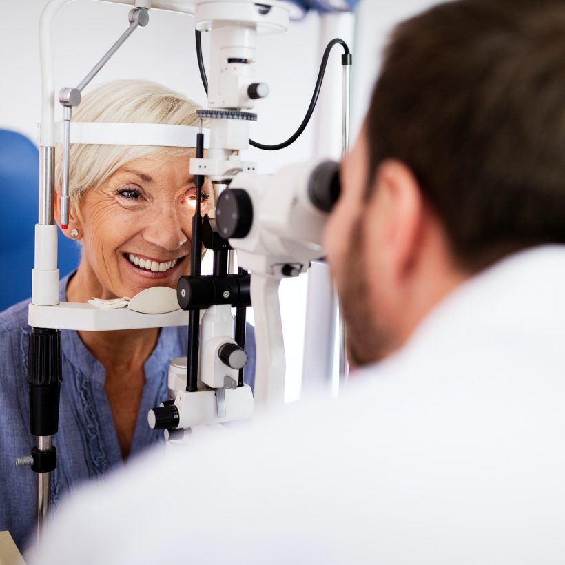 optometrist-examining-senior-woman-in-modern-ophthalmology-clinic